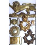 A COLLECTION OF EARLY 20TH CENTURY BRASS BRITISH ARMY INSIGNIA Including a large Kings Own