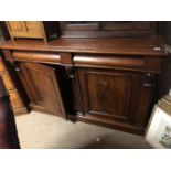 A VICTORIAN MAHOGANY SIDE CABINET With cushion drawers above panel doors, on plinth base. (135cm x