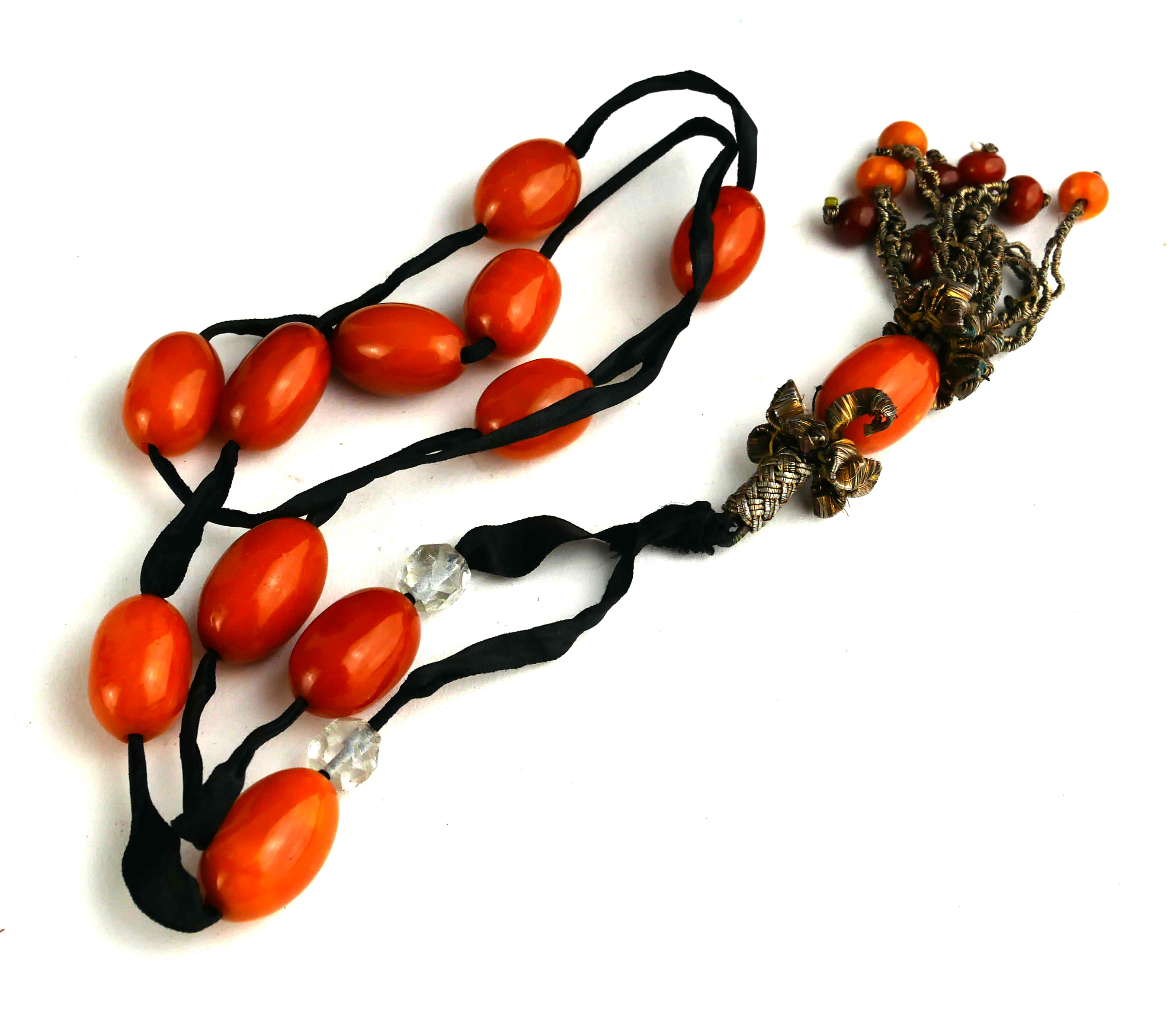 AN EARLY 20TH CENTURY OVAL AMBER BEAD NECKLACE With black fabric strap. (approx total amber weight - Image 2 of 2