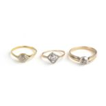 A COLLECTION OF THREE VINTAGE YELLOW METAL AND DIAMOND SOLITAIRE RINGS Having a single stone in a