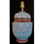 AN EARLY 20TH CENTURY FRENCH VASE AND COVER CONVERTED TO LAMP BASE With floral decoration on a