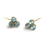 A VINTAGE PAIR OF YELLOW METAL AND BLUE TOPAZ EARRINGS Having an arrangement of three round cut