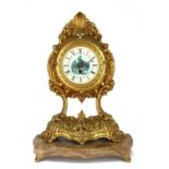 A VINTAGE GILT METAL AND ONYX MANTEL CLOCK Scrolled Rococo form with pictorial dial and shaped