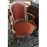 A PAIR OF FRENCH WALNUT OPEN ARMCHAIRS Wine velvet upholstery with scroll arms, raised on carved