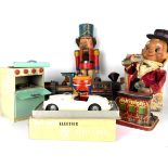 A COLLECTION OF SIX TOYS To include Chad Valley stove, Tri-Ang battery operator MGA, money box,