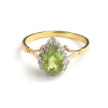 AN 18CT GOLD, PERIDOT AND DIAMOND RING The single pear form peridot edged with diamonds (size O). (