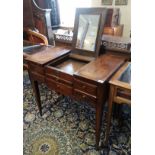 A 19TH CENTURY FRENCH PROVINCIAL OAK DRESSING TABLE With rise and fall mirrored central section,