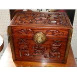 AN ORIENTAL HARDWOOD TABLE CASKET Carved with bats vases and symbols. (42cm x 30cm x 32cm)