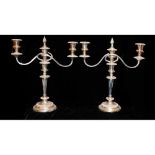 GARRARDS, A PAIR OF EARLY 20TH CENTURY SILVER PLATED CANDELABRA Having twin scroll arms, embossed