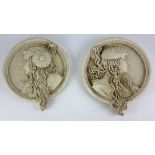 A PAIR OF CIRCULAR PLASTER RELIEF WALL PLAQUES Depicting classical maidens. (19cm x 22cm)