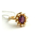 WITHDRAWN AN 18CT GOLD RING SET WITH AN AMETHYST SURROUNDED BY PEARLS (SIZE N).