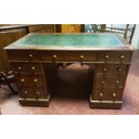 A VICTORIAN OAK TWIN PEDESTAL DESK With green tooled leather surface above arrangement of nine