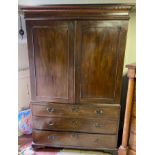 A GEORGIAN MAHOGANY LINEN PRESS With dental cornice above two panel doors enclosing hanging space