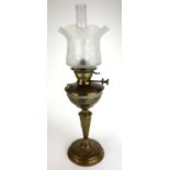 A VICTORIAN BRASS GLASS OIL LAMP Having a frosted and etched glass shade, embossed organic form