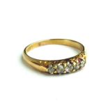 AN EDWARDIAN 18CT GOLD AND DIAMOND FIVE STONE RING Having an arrangement of graduating stones in a