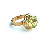 A VINTAGE 14CT GOLD AND CITRINE SOLITAIRE RING Having round cut stone in a pierced and stepped mount