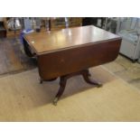 A GEORGIAN MAHOGANY PEMBROKE TABLE With real and false drawers, raised on a turned column with