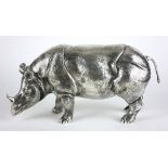 A LARGE CONTINENTAL SILVER SCULPTURE OF A RHINOCEROS Standing pose with glass eyes and fine engraved