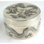 A CHINESE SILVER CIRCULAR BOX AND COVER Decorated in relief with a four toed dragon. (diameter 8cm x
