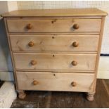 A VICTORIAN PINE CHEST Applied with four long graduated drawers, raised on turned bun feet. (102cm x
