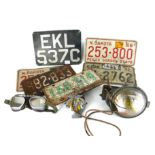 A COLLECTION OF TIN PLATE NUMBER PLATES Together with some vintage stadium motorcycle goggles, AA