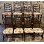 A SET OF EIGHT 19TH CENTURY STYLE OAK LADDER BACK DINING CHAIRS With rush seats including two