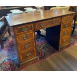 AN EDWARDIAN MAHOGANY AND SATINWOOD BANDED DESK/DRESSING TABLE Fitted with an arrangement of nine
