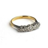 AN EARLY 20TH CENTURY 18CT GOLD AND DIAMOND FIVE STONE RING Having a row of graduated stones in an