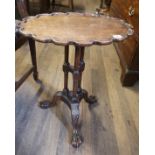 AN 18TH CENTURY DESIGN MAHOGANY OCCASIONAL TABLE The oval scalloped top raised on three turned