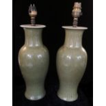 A PAIR OF CHINESE CELADON GLAZED VASES CONVERTED TO LAMPS. (37cm)