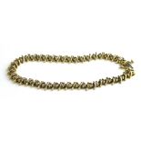 A VINTAGE 14CT GOLD AND DIAMOND TENNIS BRACELET Having a single row of round cut diamonds. (each