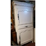 A 19TH CENTURY DESIGN CREAM PAINTED HOUSE KEEPER?S CABINET With two ogee panelled doors centred with