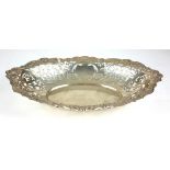 AN EARLY 20TH CENTURY SILVER OVAL SWEETMEAT DISH With scrolled edge and pierced decoration,