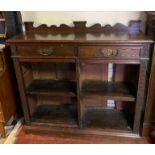 A VICTORIAN CARVED OAK BOOKCASE With two drawers above open shelves. (122cm x 40cm x 108cm)