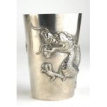A CHINESE SILVER BEAKER Entwined in relief with a four toed dragon. (8cm)