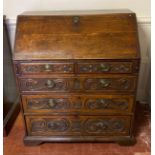 AN 18TH CENTURY OAK FALL FRONT WRITING BUREAU With fitted interior above two short and three long