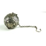 A CHINESE WHITE METAL POCKET INCENSE BURNER Spherical form with pierced floral decoration and gimbal