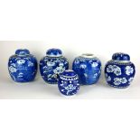 A COLLECTION OF FIVE CHINESE BLUE AND WHITE PORCELAIN GINGER JARS Decorated with prunus sprigs,