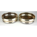 A PAIR OF 20TH CENTURY SILVER AND OAK WINE CIRCULAR CASTERS Hallmarked London, 1989. (approx 13cm)