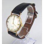 ROTARY, A VINTAGE 9CT GOLD GENT?S WRISTWATCH Having a silver tone circular dual with gilt number