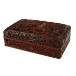 A CHINESE CINNERBAR LAQUER RECTANGULAR BOX With fine carved decoration of figures in a mountainous