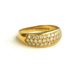 AN 18CT GOLD RING, SET WITH THREE ROWS OF DIAMONDS (SIZE Q/R).