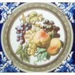 A LARGE CONTINENTAL HAND PAINTED CERAMIC TILE Having hand painted fruit to centre and blue and white