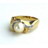 A VINTAGE 18CT GOLD, PEARL AND DIAMOND RING Having a single pearl edged with diamonds in a