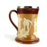 A VICTORIAN DOULTON LAMBETH 'GOLFING' TANKARD Having applied figures of golfers to the stoneware