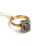 AN EDWARDIAN STYLE 9CT GOLD, AMETHYST AND DIAMOND DRESS RING The emerald cut amethyst claw set to