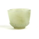 A CHINESE JADE MINIATURE CUP Hand carved with fluted base. (approx 3cm)