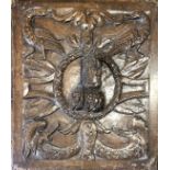 A 16TH/17TH CENTURY CARVED OAK PANEL With central facial mask surrounded by birds and foliage. (40cm