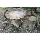A RECONSTITUTED STONE BIRD BATH FORMED AS A LARGE CLAM SHELL Decorative scrolling base, together