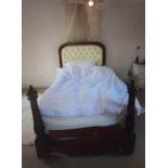 A LARGE VICTORIAN MAHOGANY SINGLE BED With barley twist supports, draped canopy above upholstered